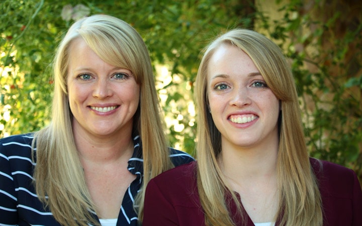 About us page with Borrowed Bites authors Danielle and Misty smiling in front of greenery. 