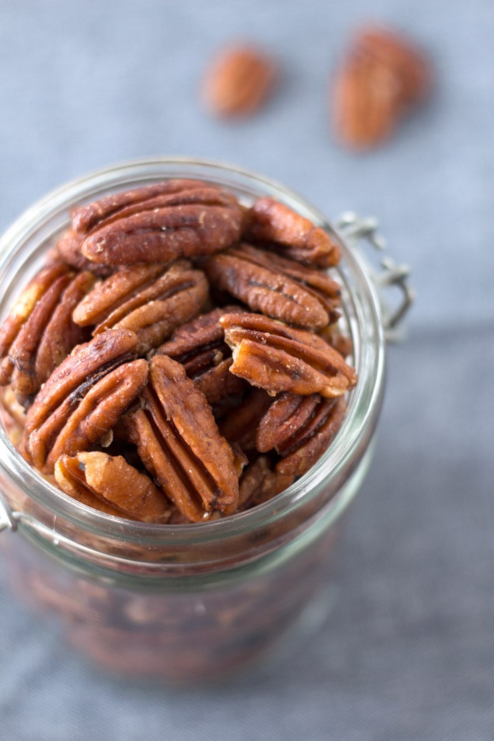Close up of mapled pecans in a jar