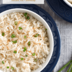 Overhead of two bowls of toasted coconut rice with text overlay