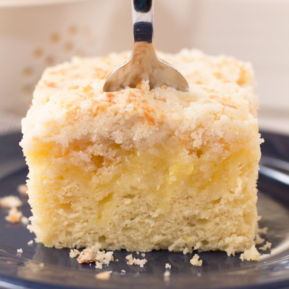 Lemon Curd Coffee Cake on a blue plate with a fork in it. 