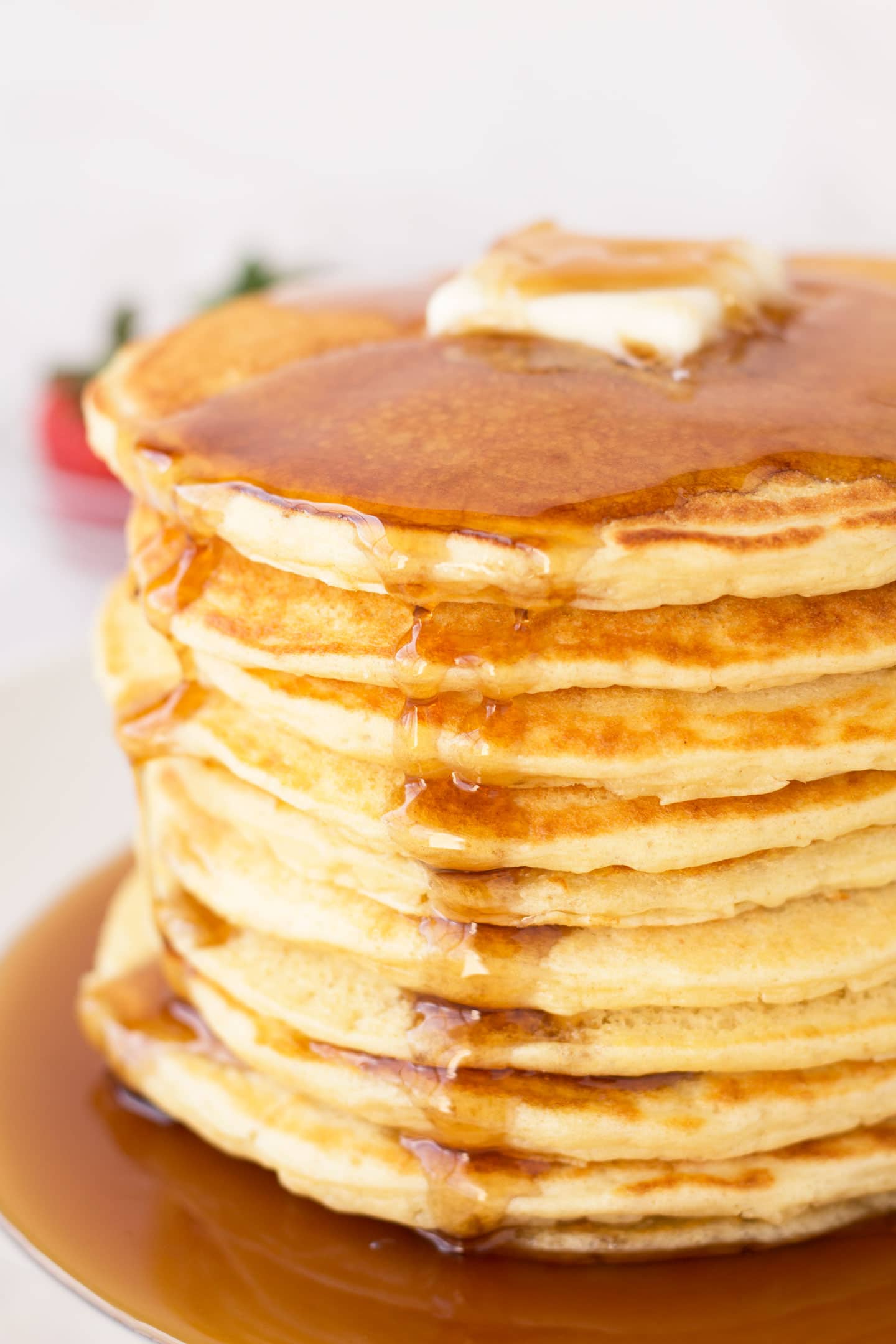 Tall stack of Famous Farm Pancakes (with buttermilk) with syrup
