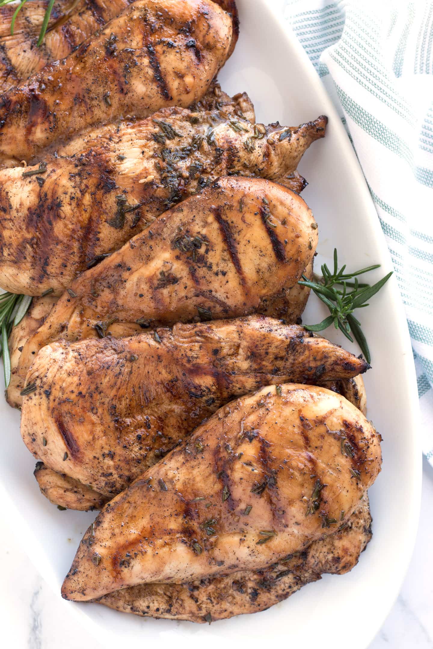 Overhead view of grilled chicken on platter.