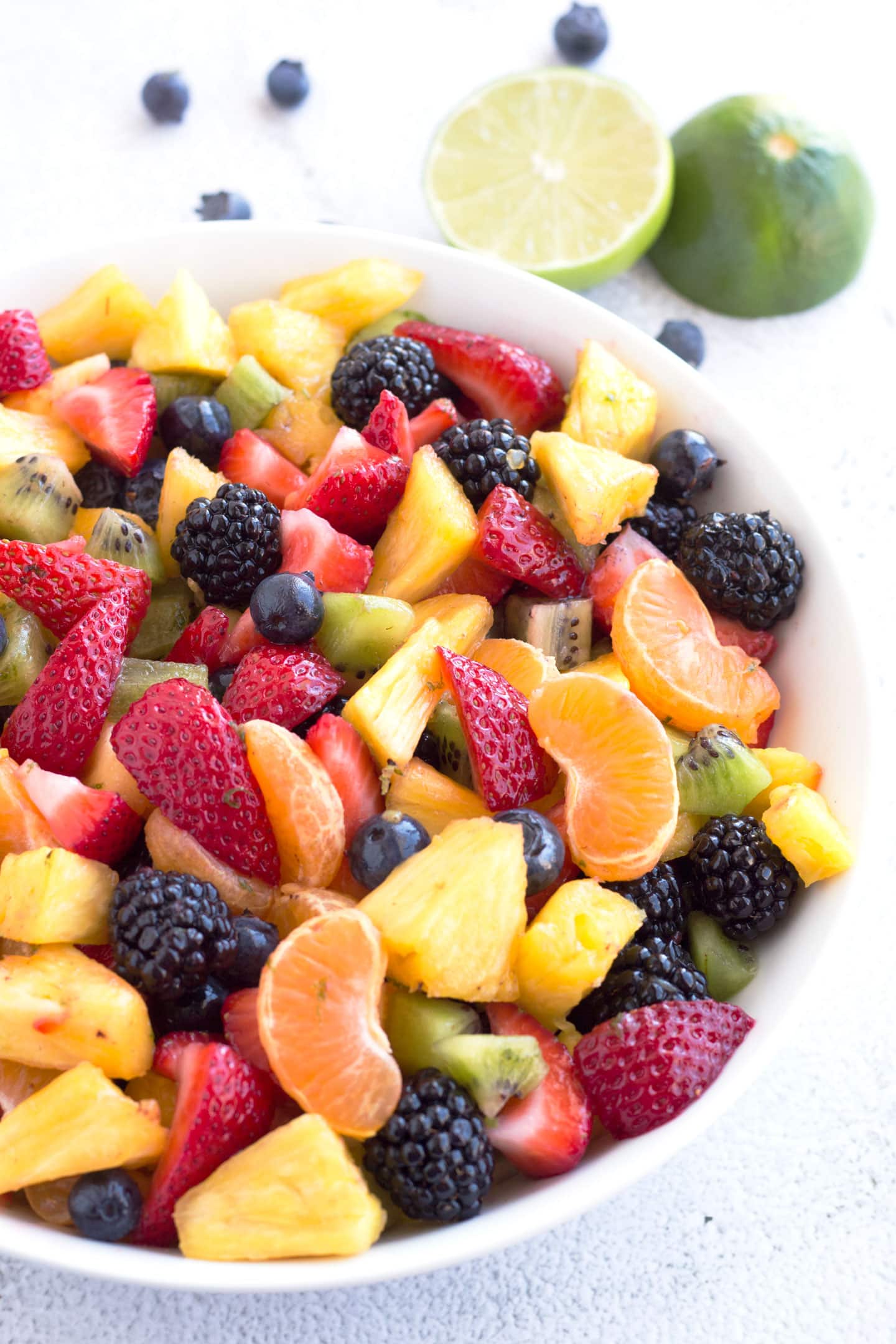 Bowl of Summer Fruit Salad with Honey Lime Dressing on counter