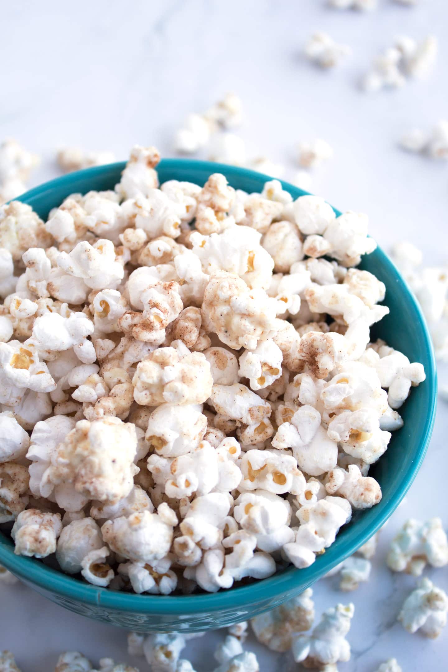 Blue bowl filled with White Chocolate Churro Popcorn