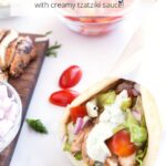 Tzatziki sauce on grilled chicken gyro with graphic overlay