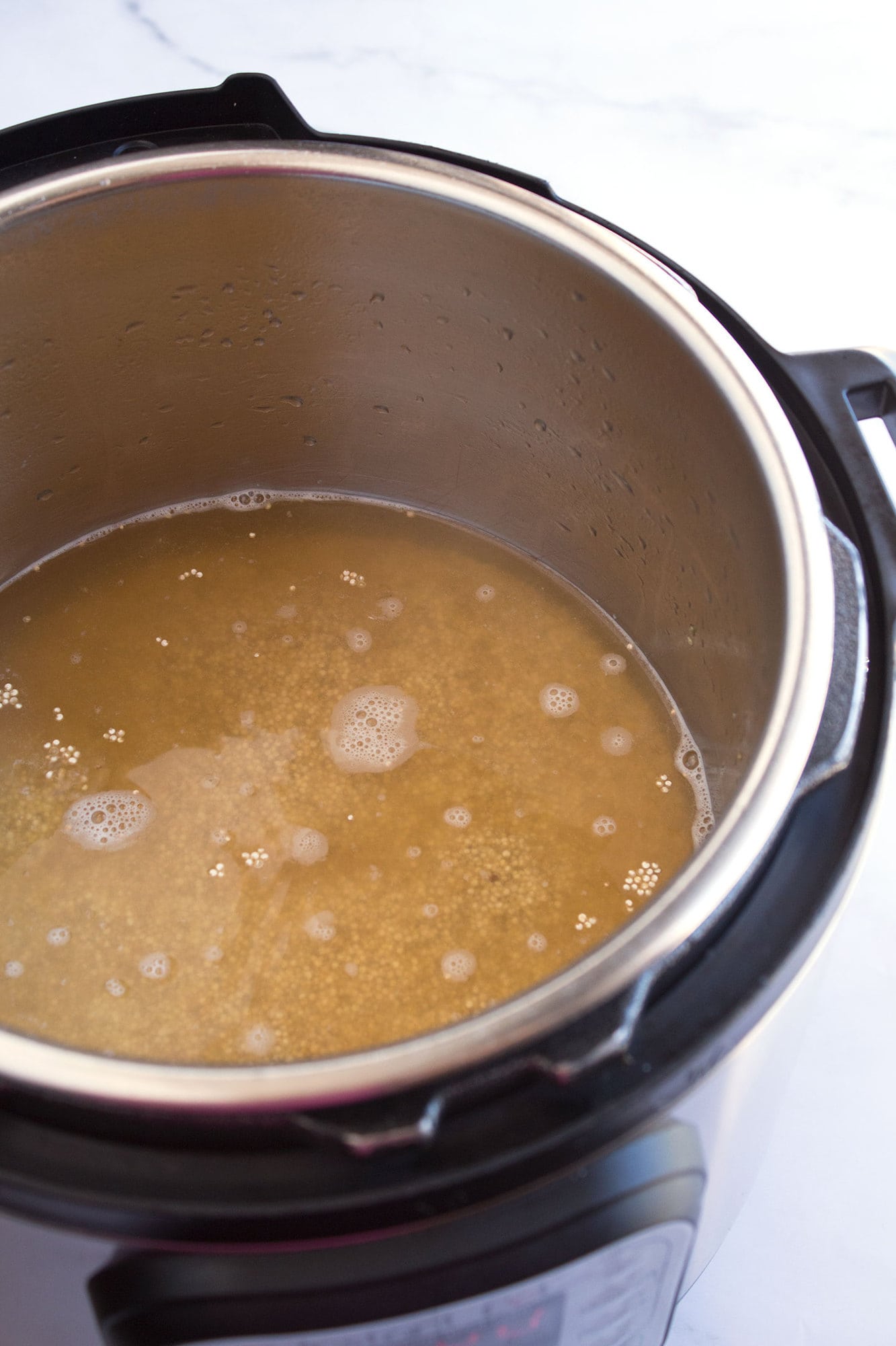 Liquid and quinoa in pot
