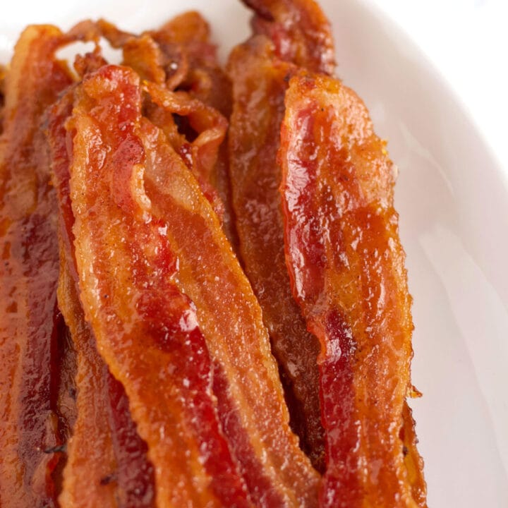 Strips of candied bacon on a platter.