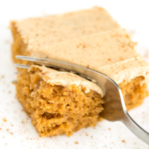 Fork cutting into piece of pumpkin sheet cake