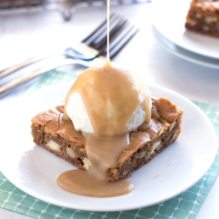 Pouring maple sauce on a white chocolate blondie sundae