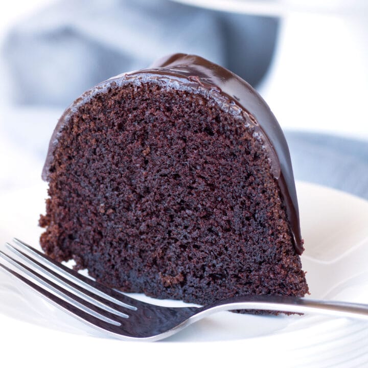 Slice of The Perfect Chocolate Bundt Cake on plate with fork