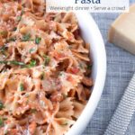 Bowl of Chicken Piccata Pasta with parmesan cheese with text overlay