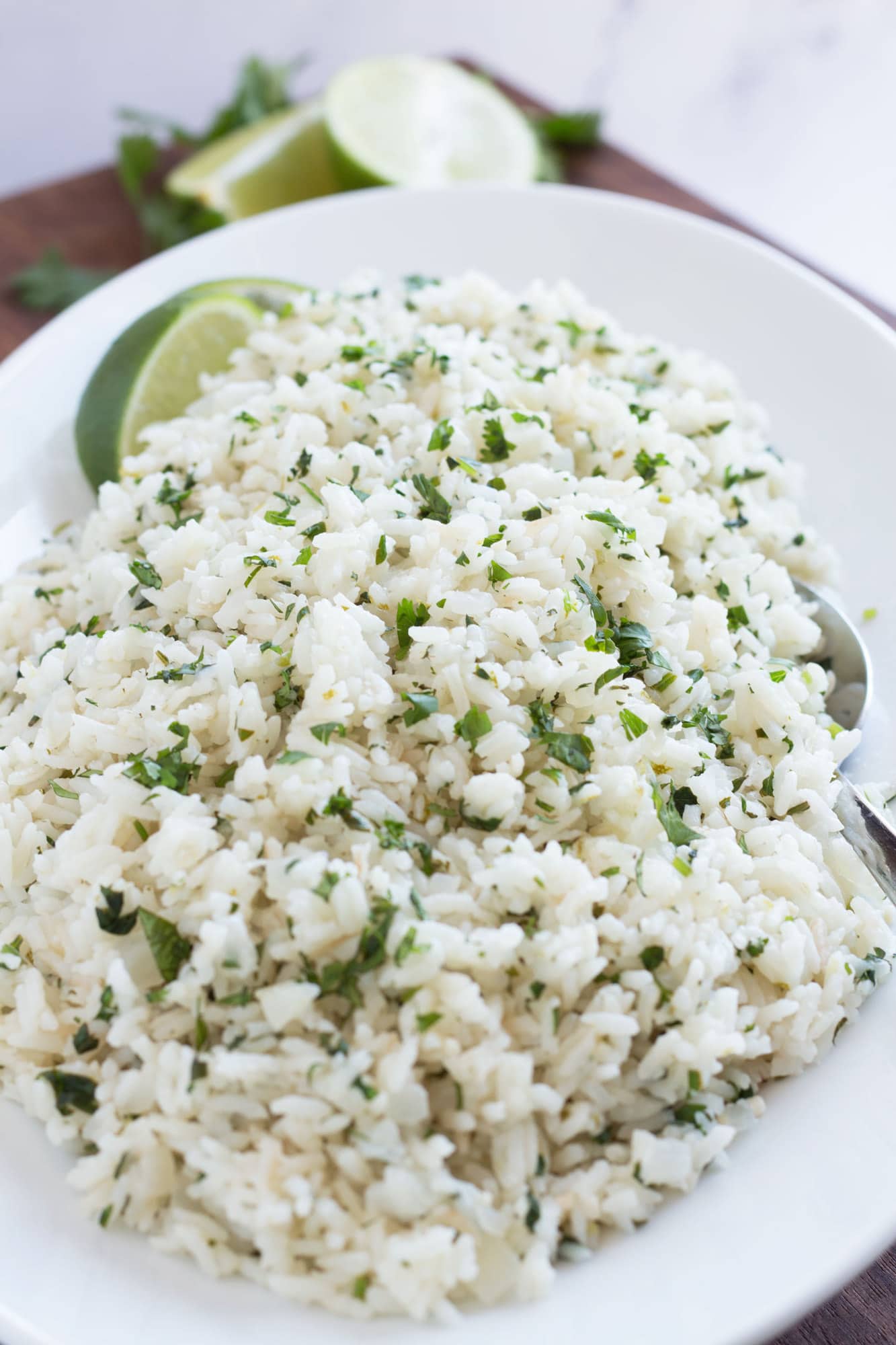 Cilantro rice on platter with serving spoon.