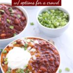 Bowl of chili with toppings and graphic overlay