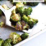 Spatula of oven roasted broccoli with text overlay