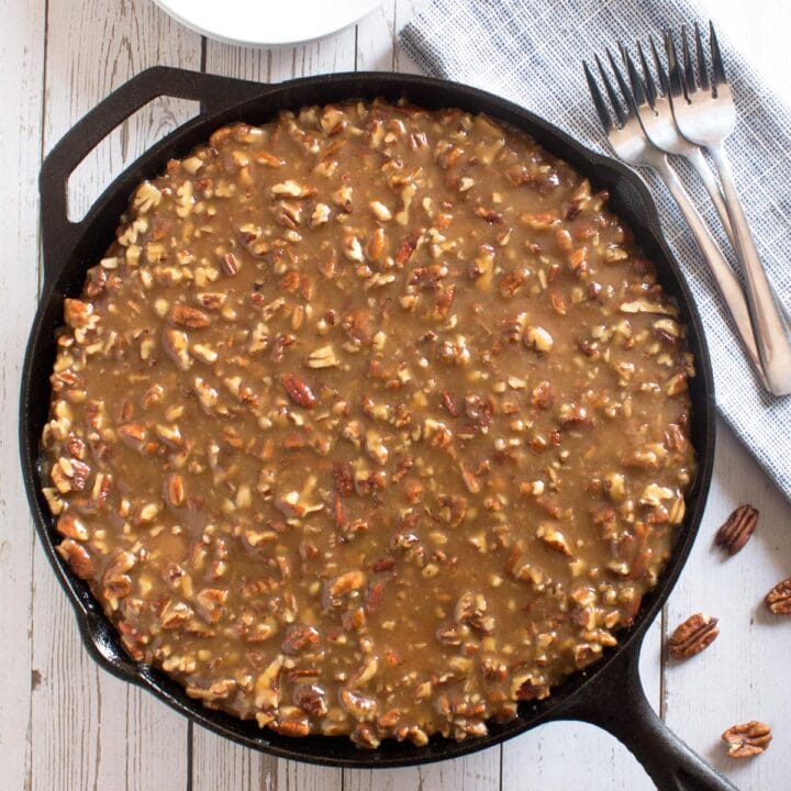 Overhead of cast iron skillet cake with praline topping.