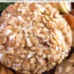 Classic cheese ball recipe on cutting board with crackers and fruit