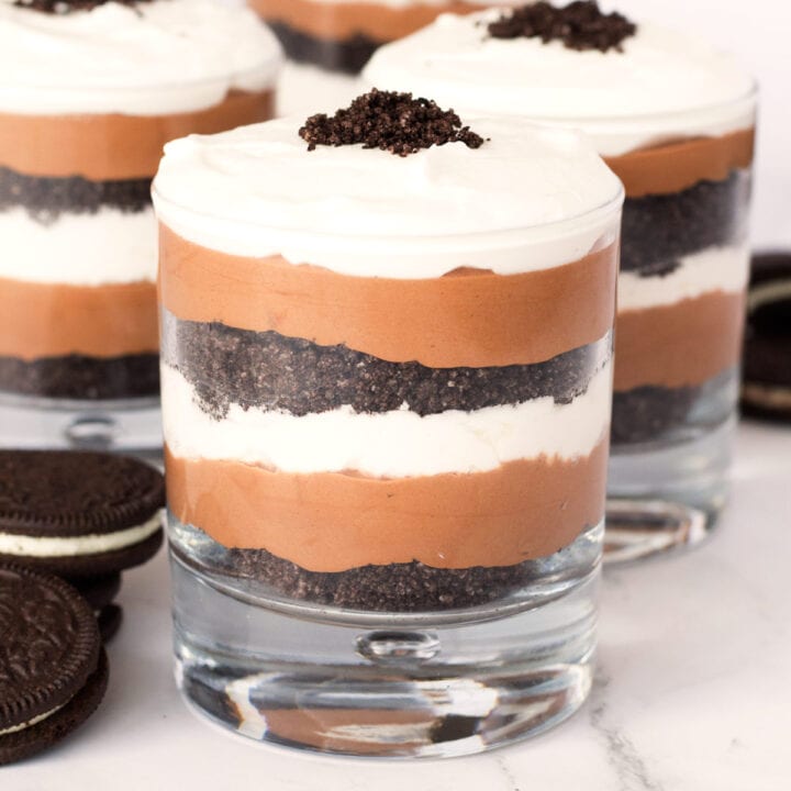 Parfait glass filled with chocolate, oreos, and whip cream.