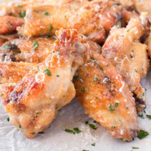 Close view of crispy oven baked chicken wings with garlic parmesan sauce