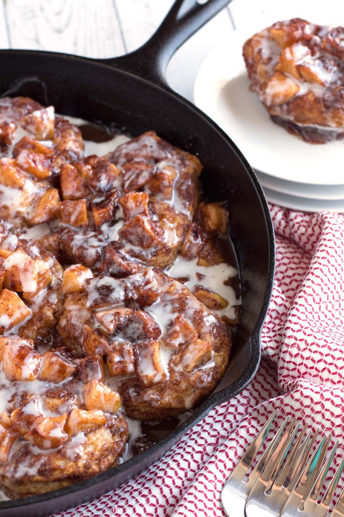 Cast iron pan filled with apple pie biscuits.