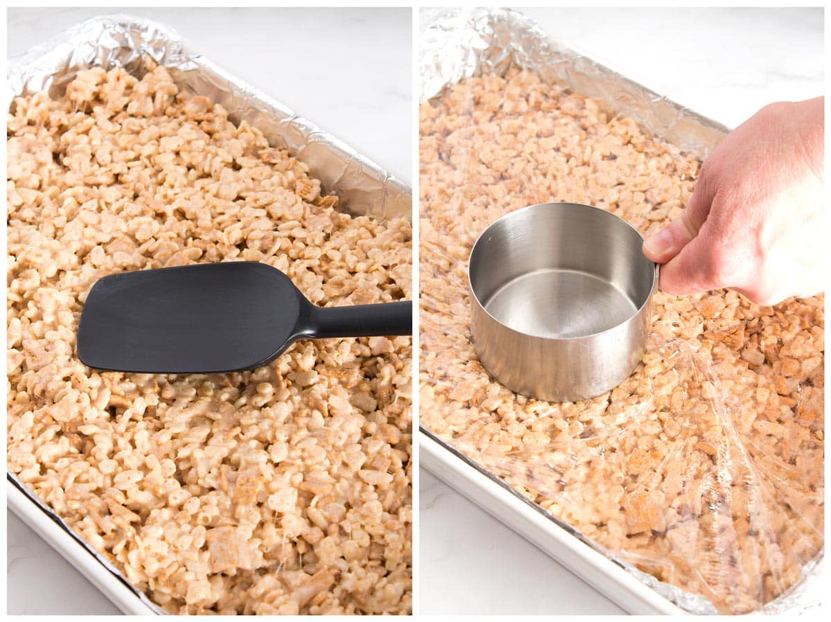 Pressing soft rice krispie treats into pan with spatula and measuring cup.