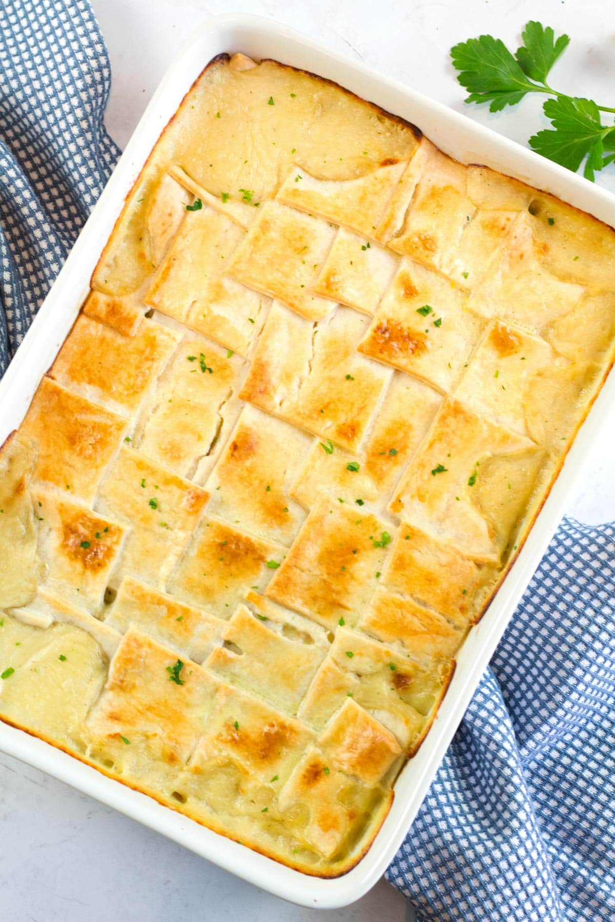 Square pieces of pie crust over pot pie filling made with rotisserie chicken baked to golden brown.