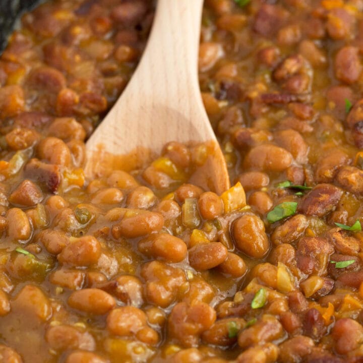 Spoon in thick syrupy canned beans that are doctored up with bacon and aromatics for homemade flavor.
