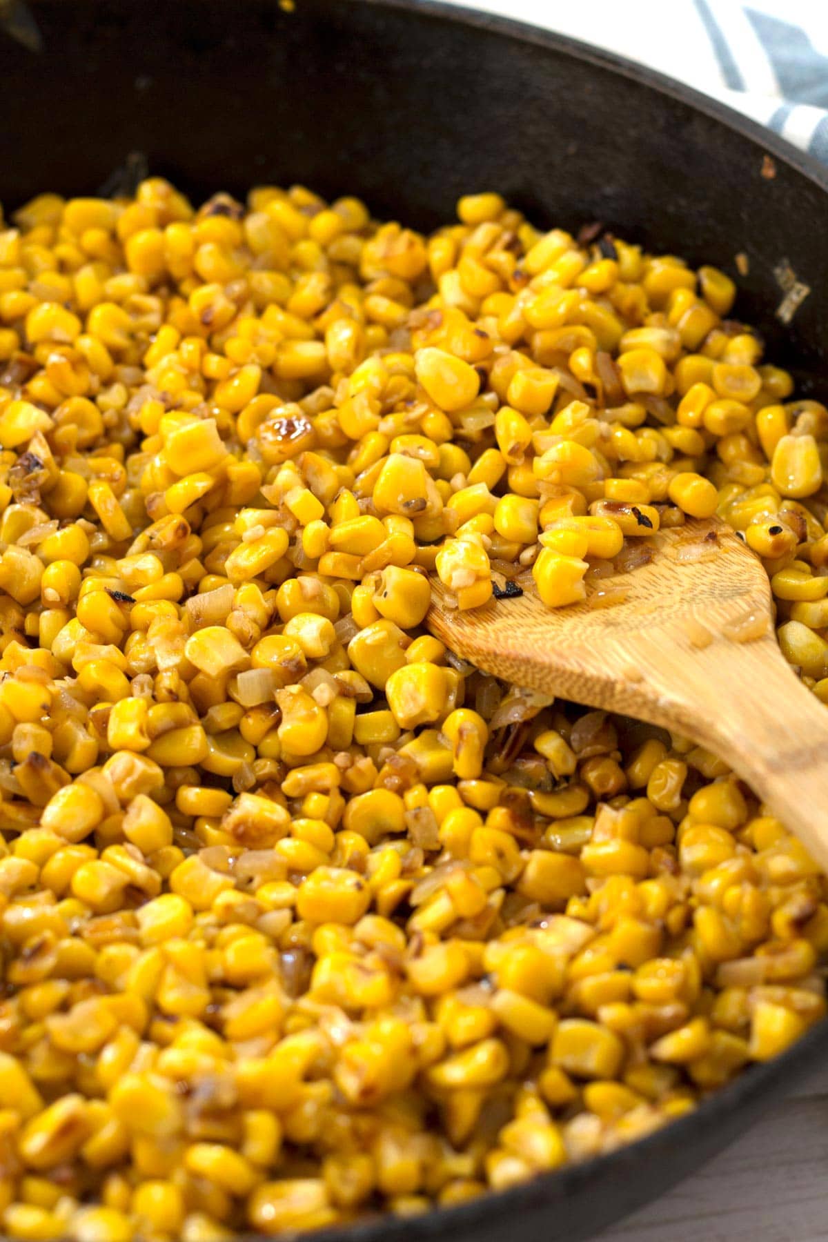 Pan roasted corn with onions and garlic in cast iron skillet.