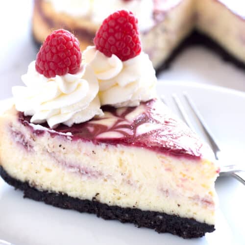 Slice of white chocolate cheesecake on white plate.
