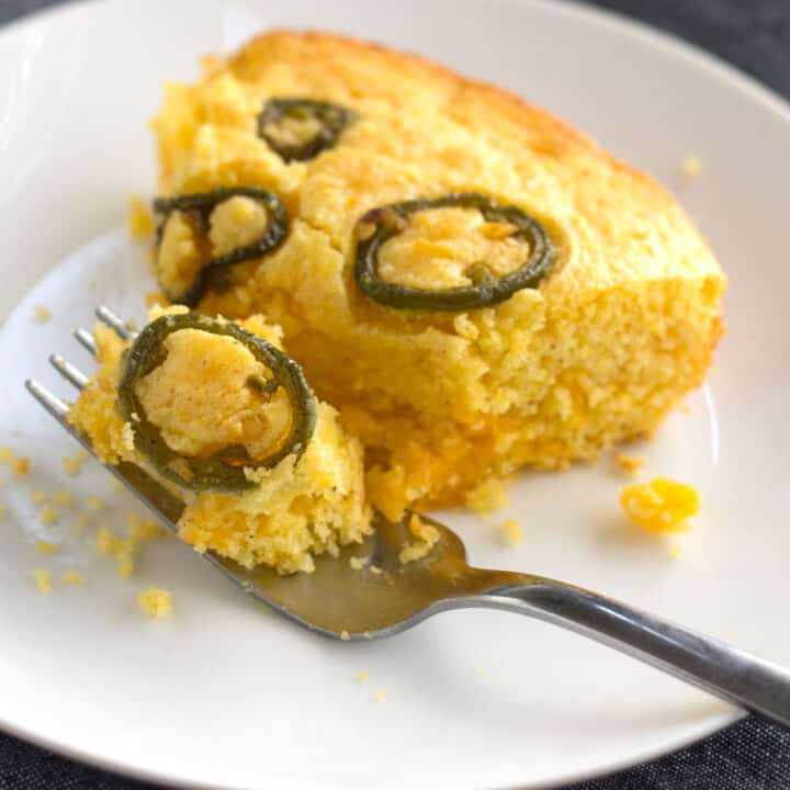 Upclose piece of Jiffy Jalapeno Cornbread on a plate with a fork.