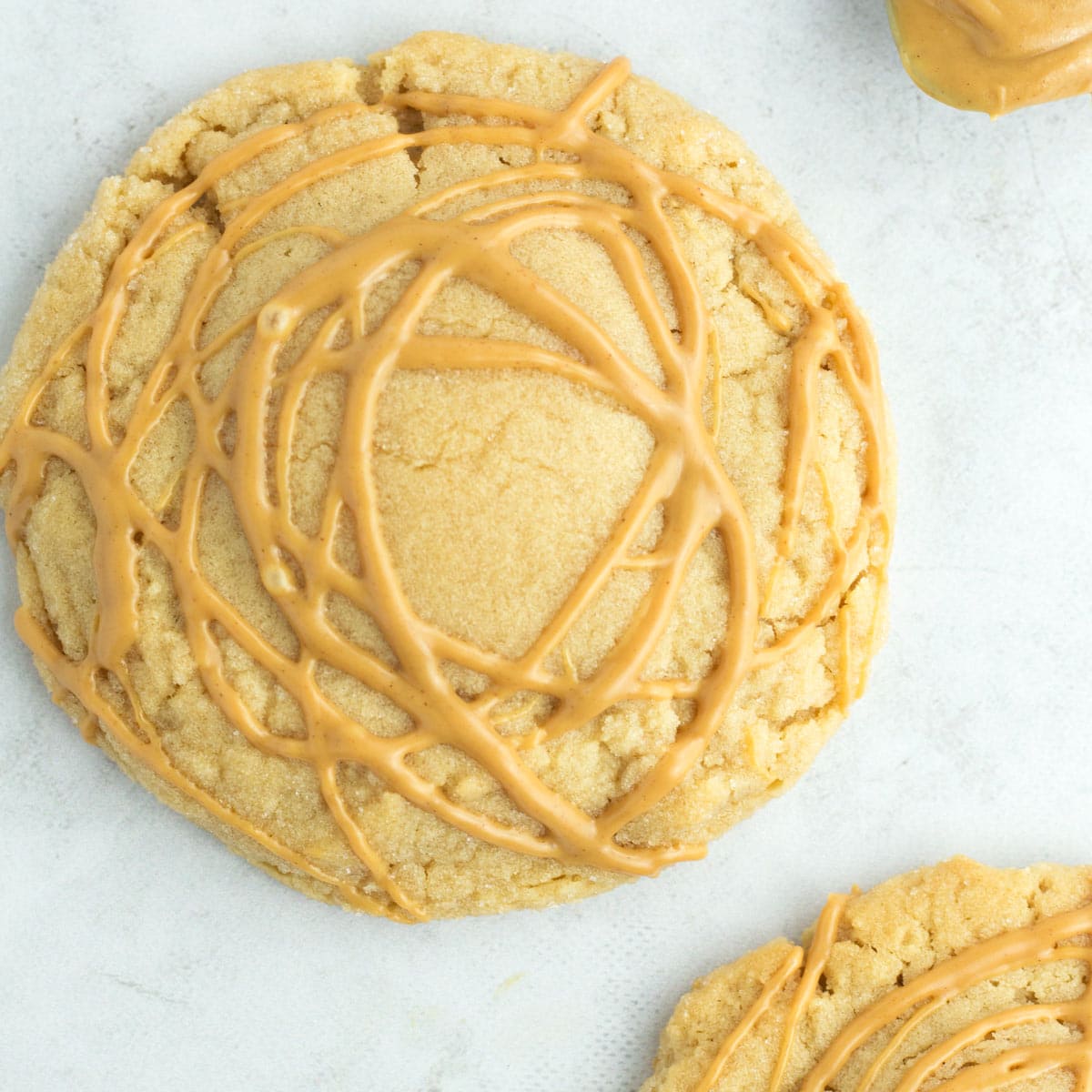 A bakery-sized peanut butter cookie on the counter. 