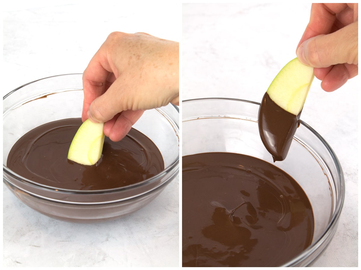 Dipping apples in chocolate and wiping excess chocolate off.