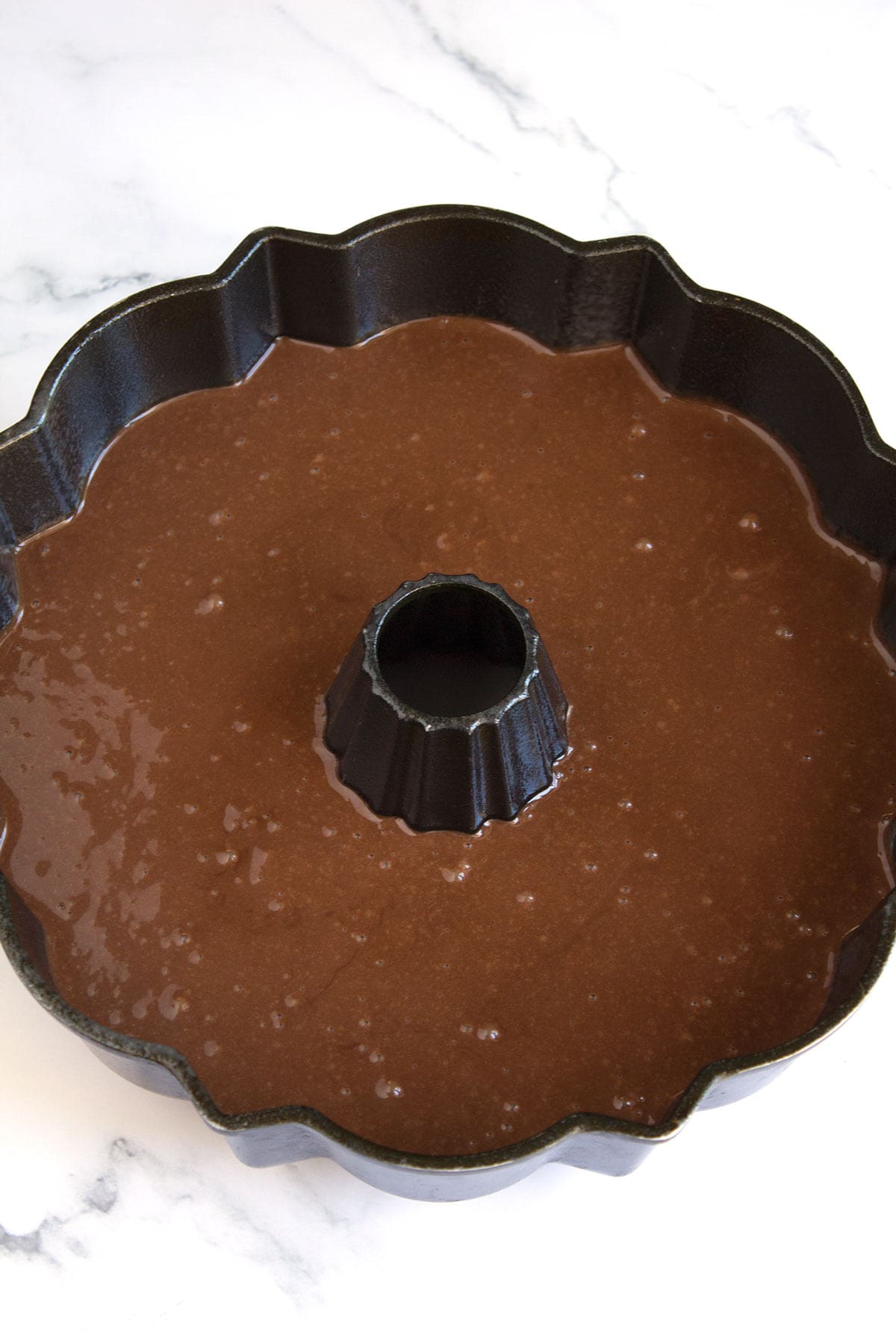 Chocolate Bundt cake batter in a prepared Bundt pan.