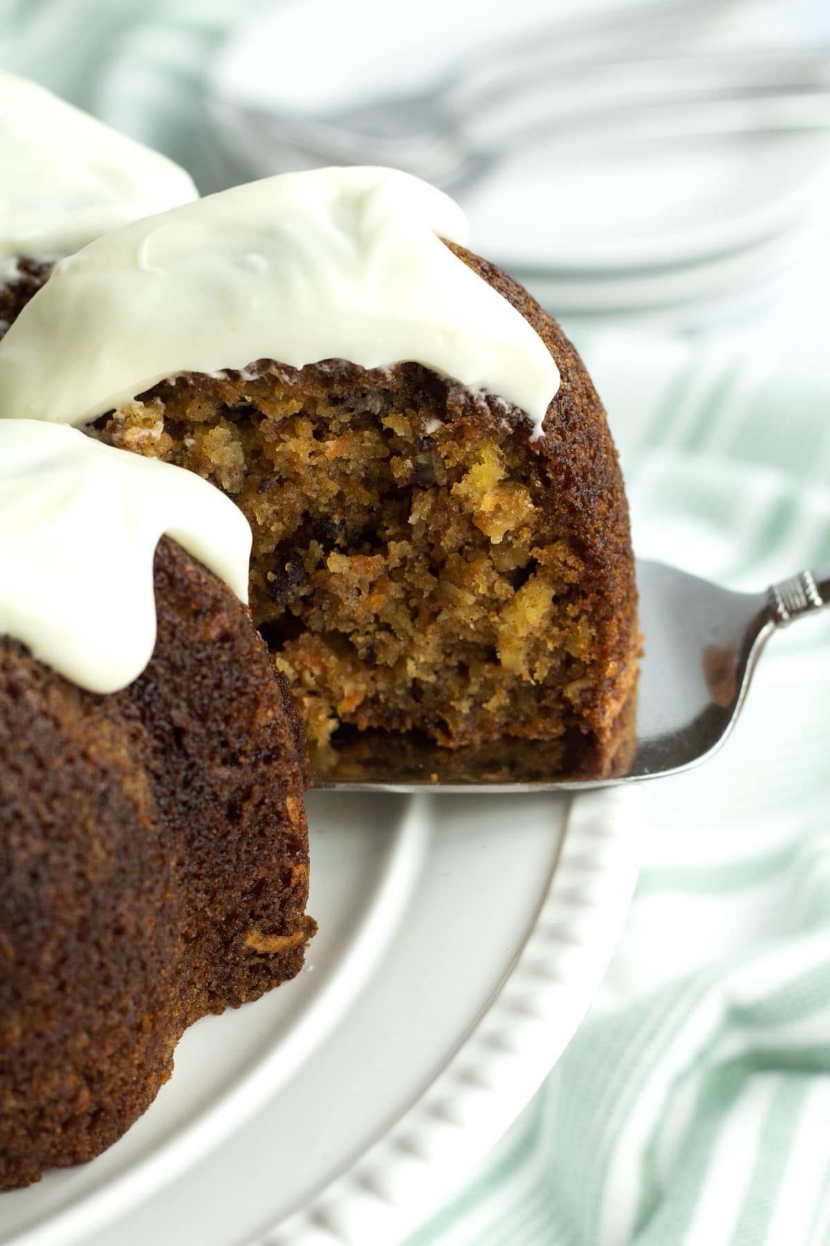 Slice of Hummingbird Bundt Cake with Lightened Cream Cheese Frosting.