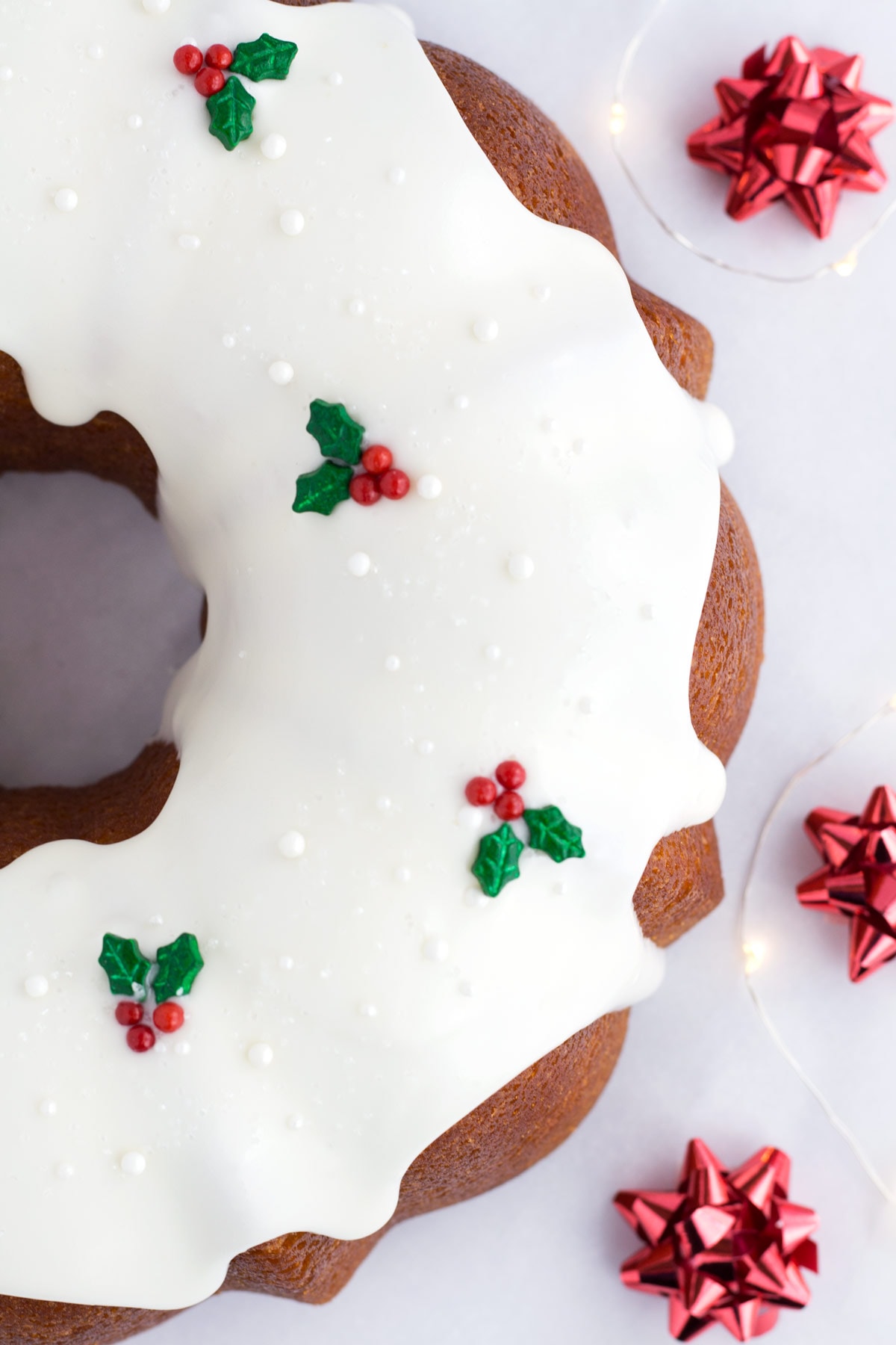 Shimmery sprinkles and holly and berry candies on a Christmas Bundt cake.