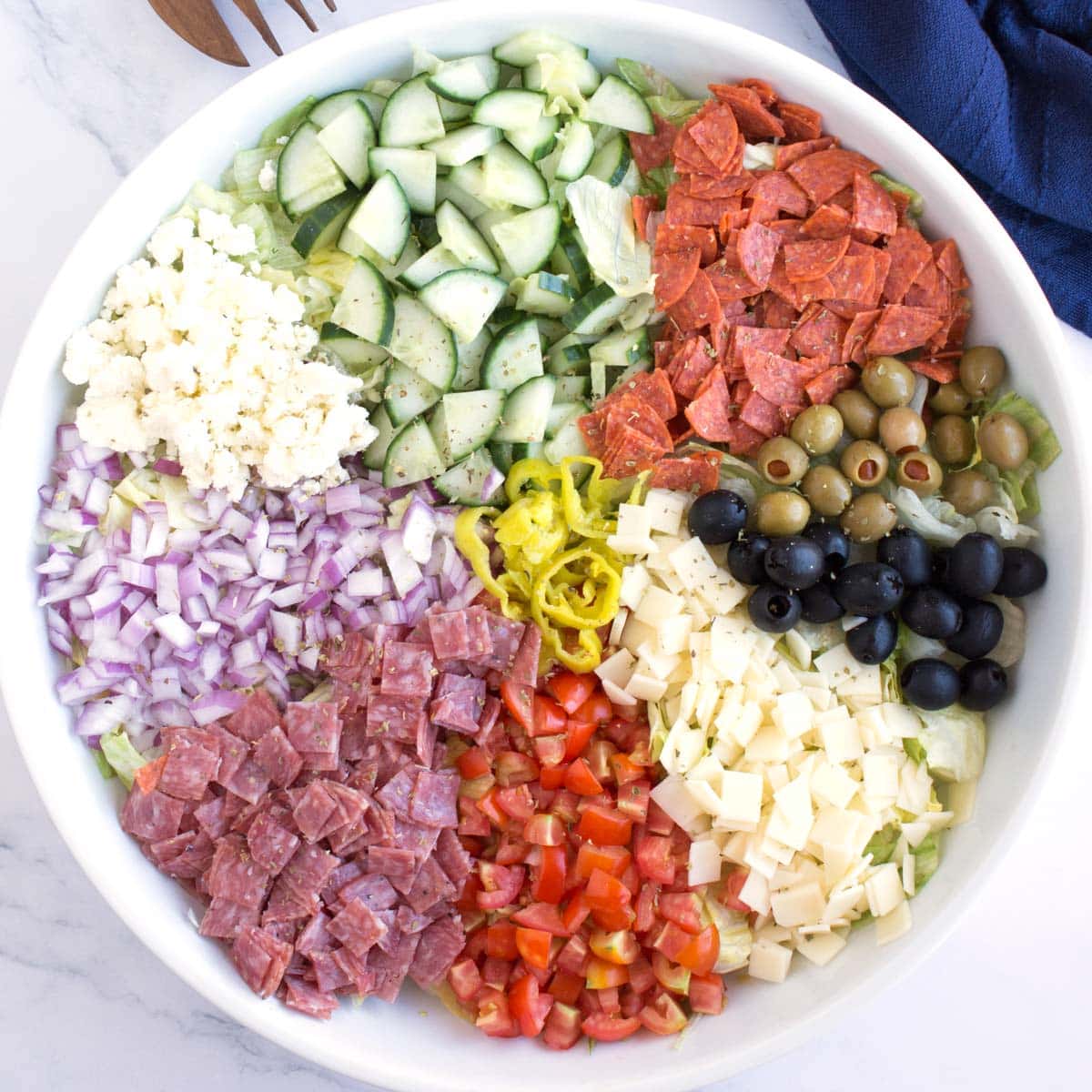 Chopped antipasto salad ingredients in large bowl.