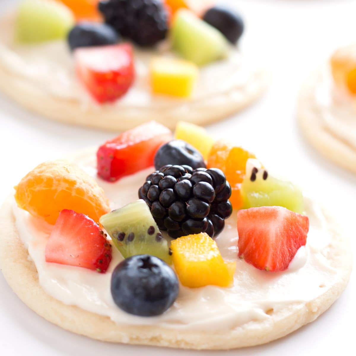Small fruit pizzas on counter top.