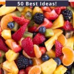 Colorful fruit salad in a white bowl with text overlay on the top and bottom of the image.