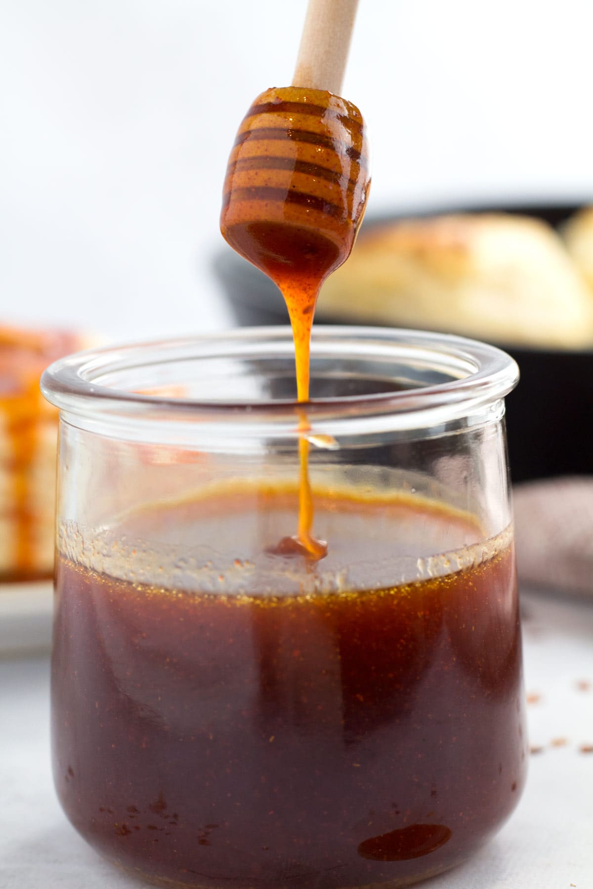 Jar filled with mouthwatering spicy honey sauce.