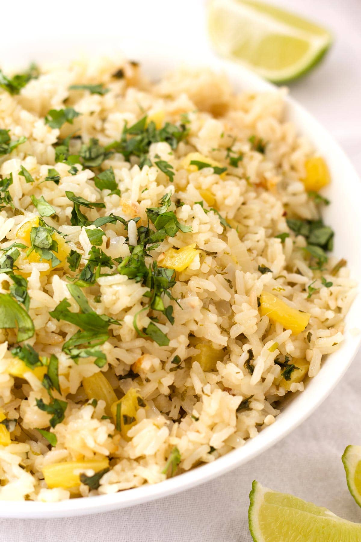 White bowl with cilantro pineapple rice.