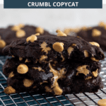Chocolate peanut butter cookies stacked on wire rack with teal towel underneath and text overlay on top.