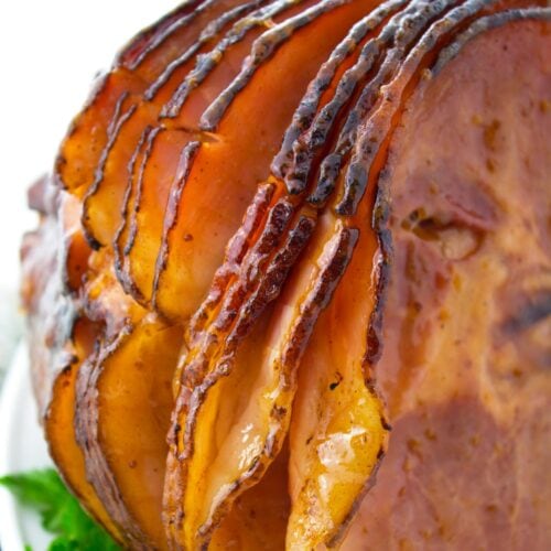 Caramelized slices of glazed spiral ham cooked in roaster.