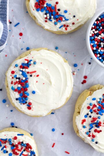 A variety of patriotic and memorial day cookies, including red, white, and blue frosted sugar cookies and chocolate-dipped Oreos, arranged festively.