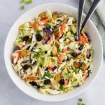 Coleslaw with apples in a serving bowl.