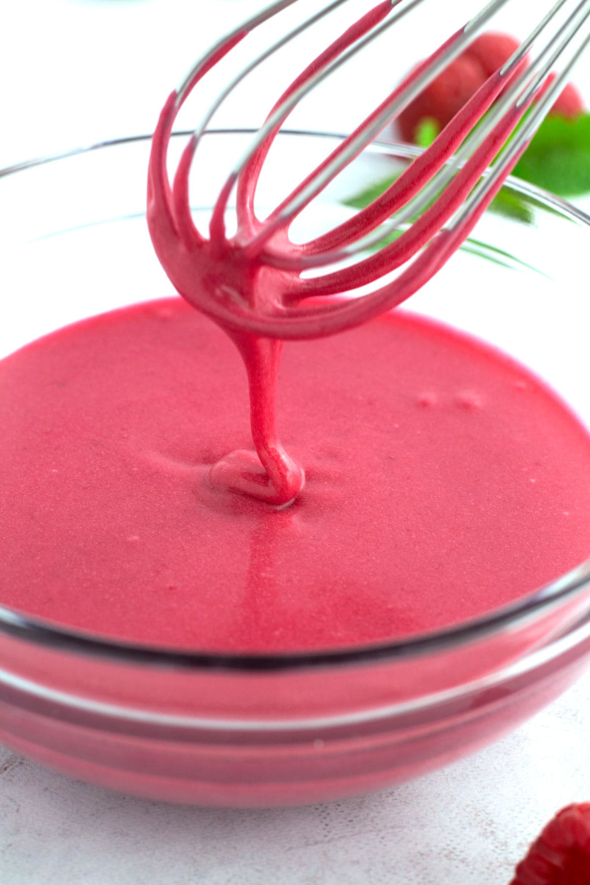 Whisking together the raspberry glaze ingredients.