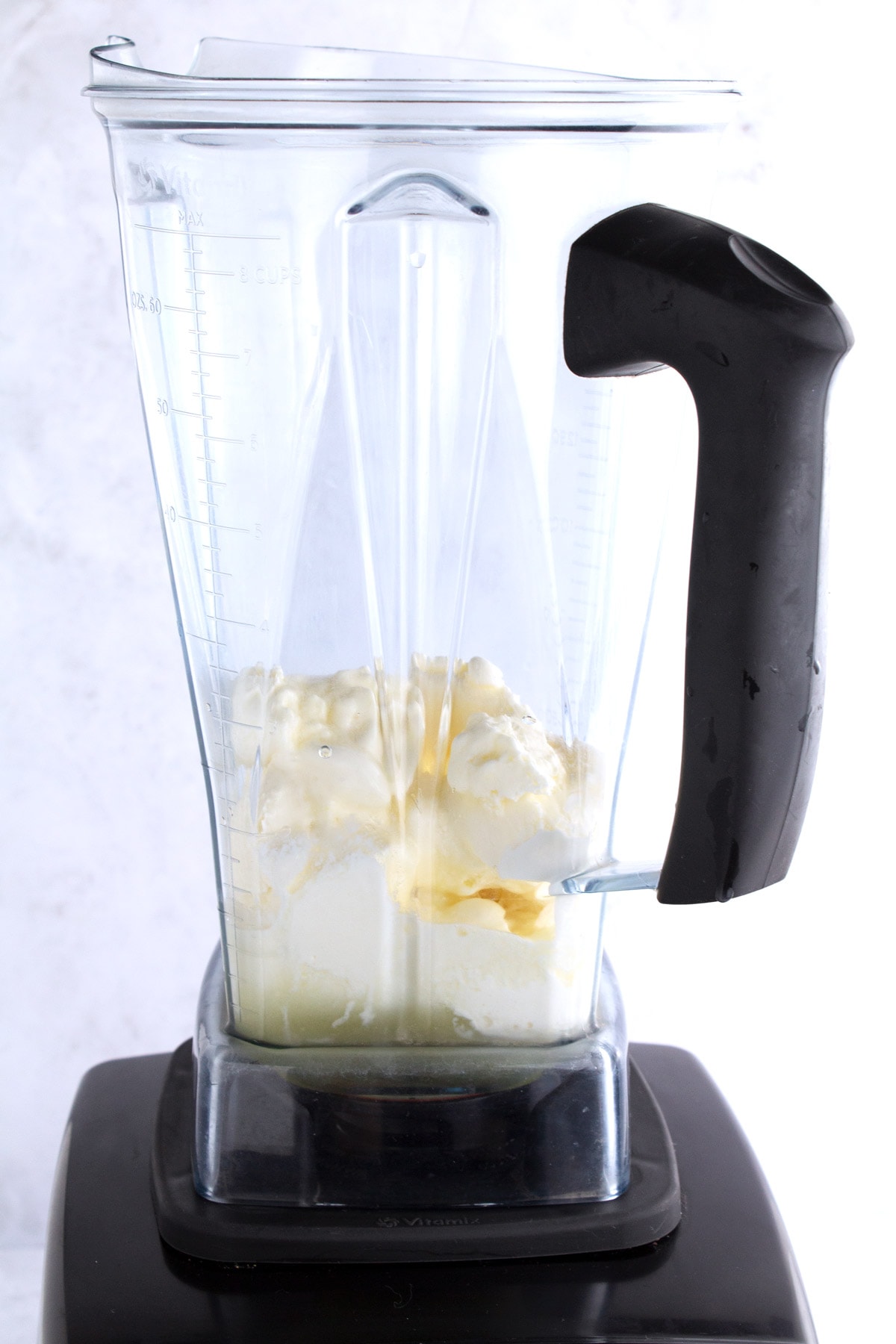 Blender with un-mixed ice cream and lemonade.