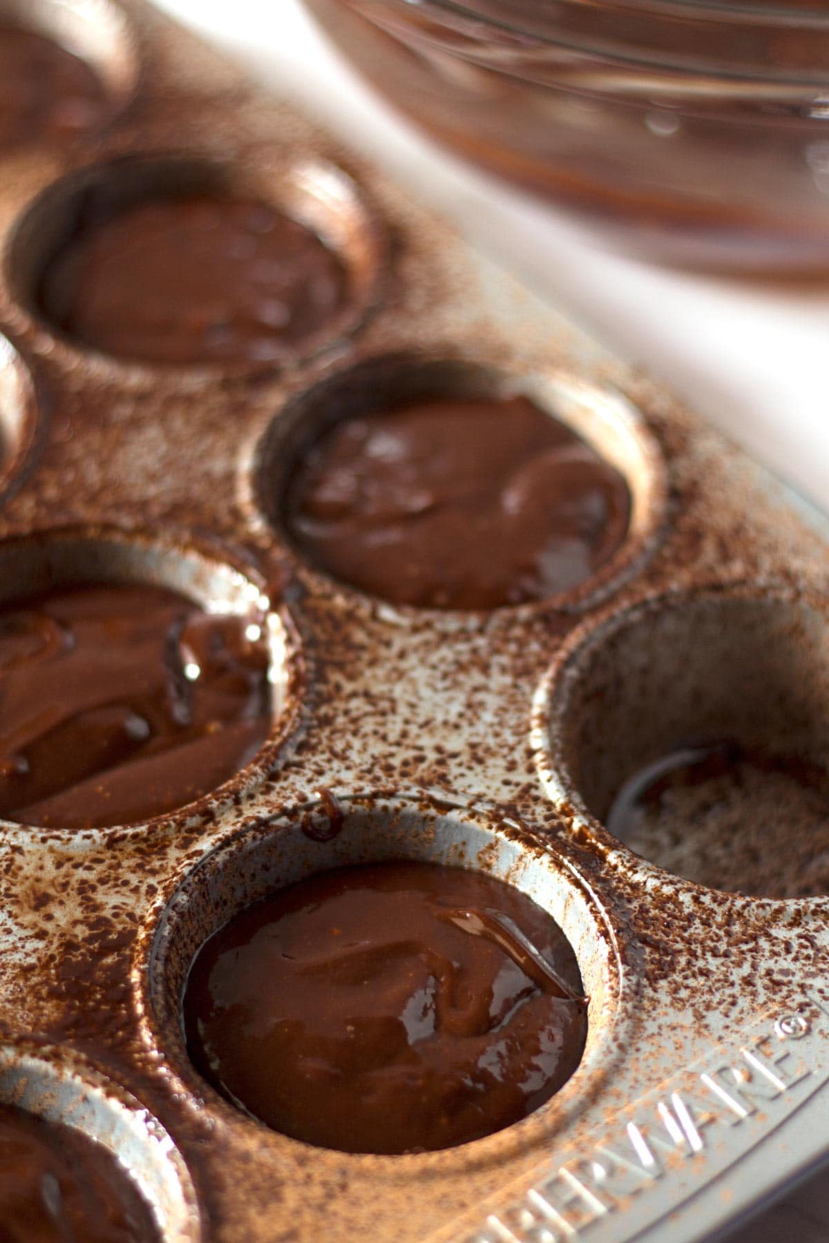 Muffin tin filled three-fourths of the way with lava cake batter.