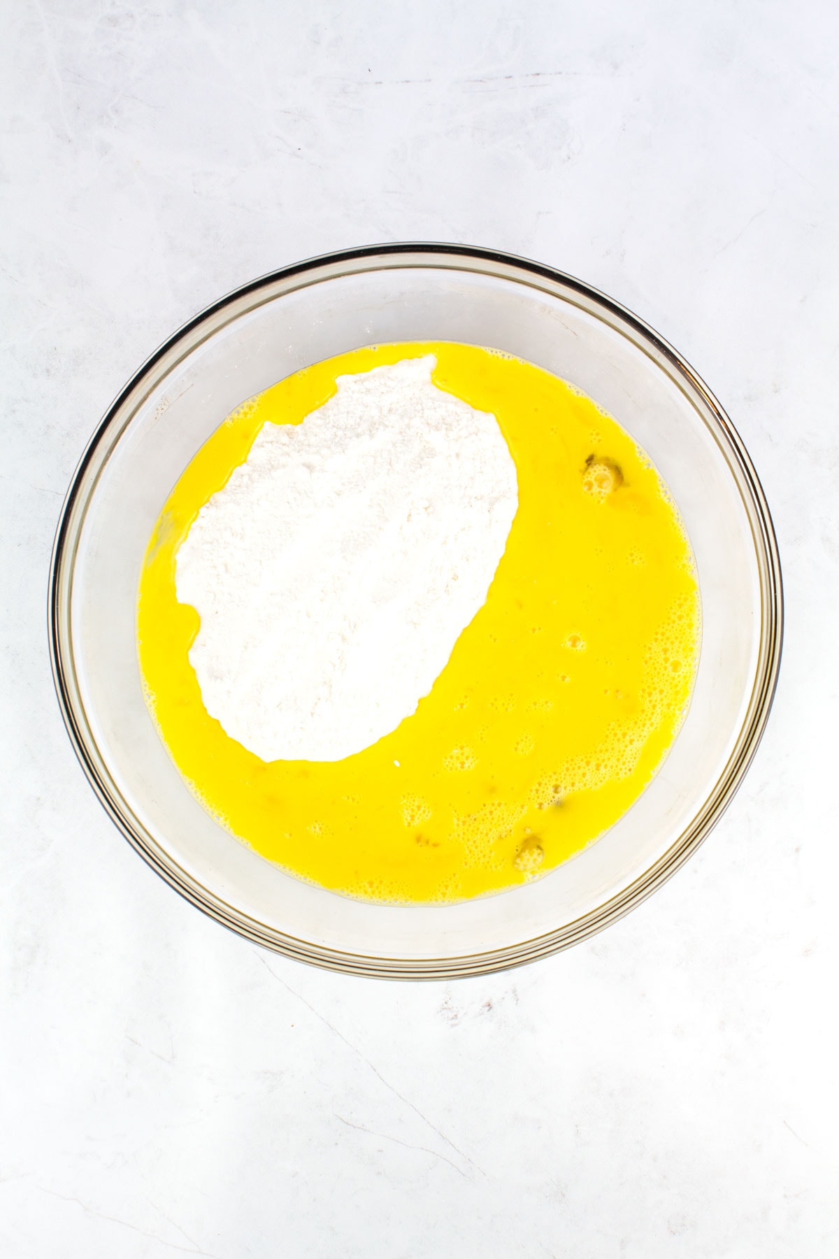 Egg yolks and flour mixed into a bowl.