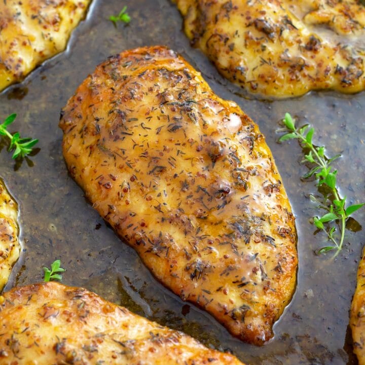 Chicken in electric skillet with maple mustard sauce and fresh thyme sprigs.
