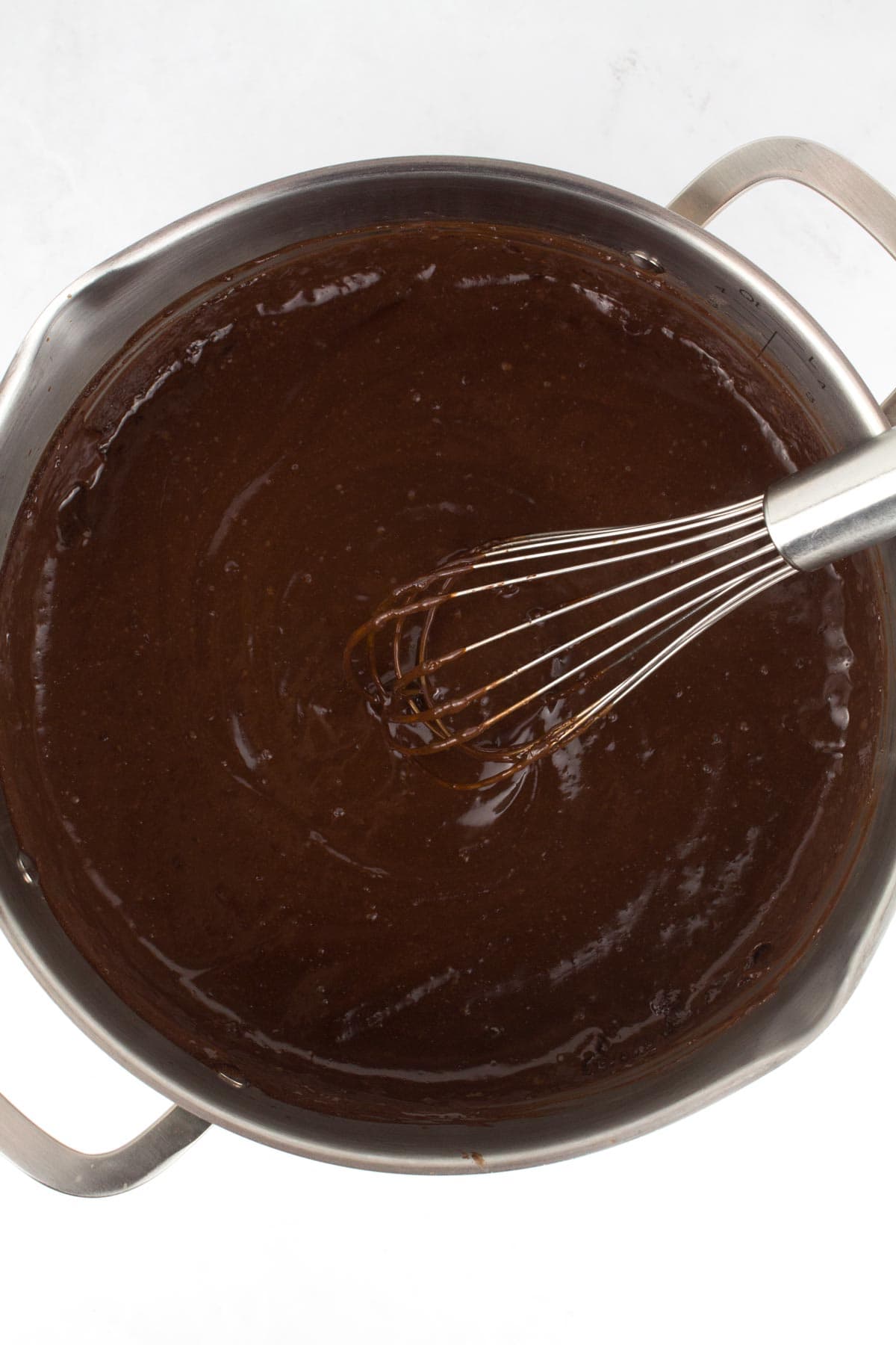Thickened filling for peanut butter chocolate pie in pot.