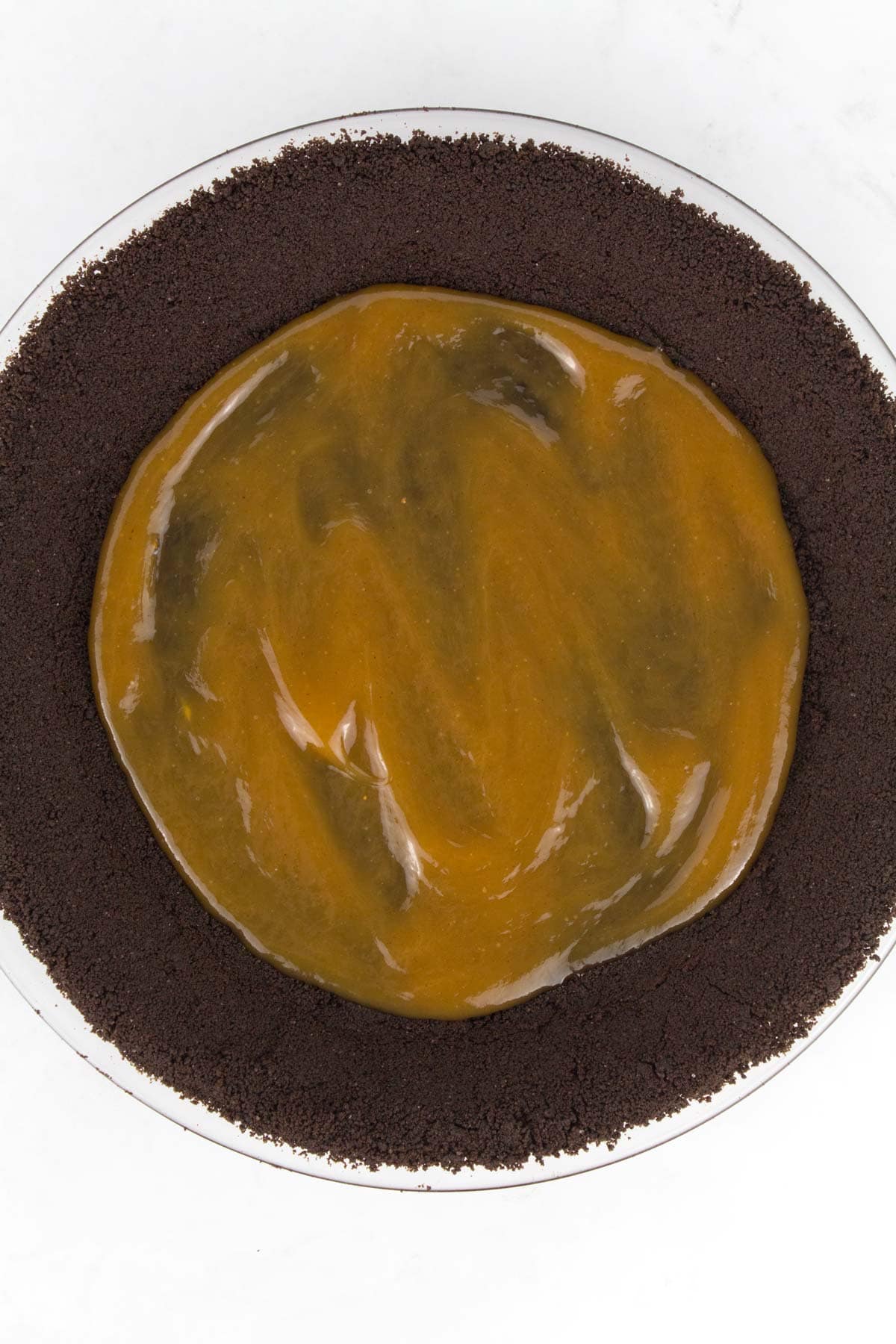 Ganache spread on crust of Chocolate Peanut Butter Pie.